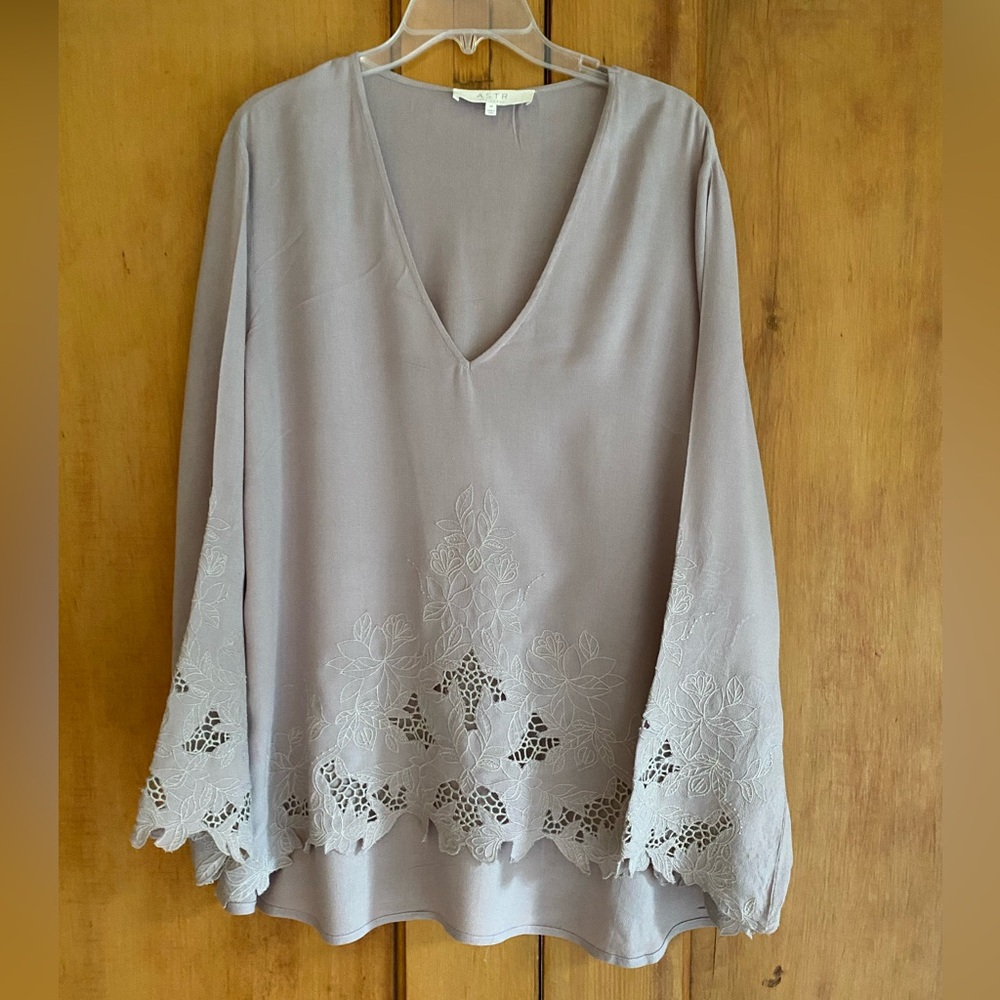 Light lavender colored long sleeve blouse with cut outs